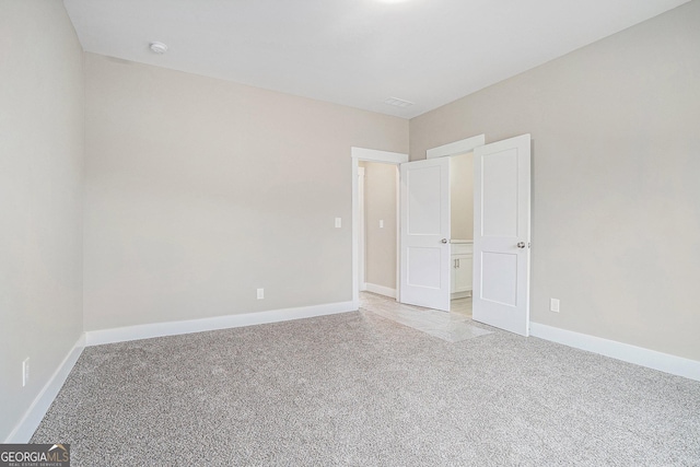 unfurnished bedroom featuring light carpet