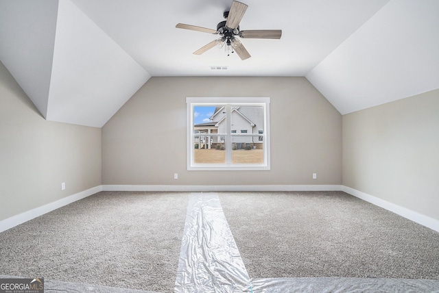 additional living space featuring vaulted ceiling, ceiling fan, and carpet flooring