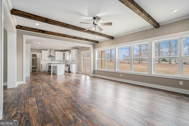 unfurnished living room featuring dark wood-type flooring, ceiling fan, and beam ceiling