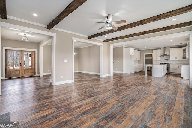 unfurnished living room with ceiling fan, beam ceiling, ornamental molding, dark hardwood / wood-style flooring, and french doors