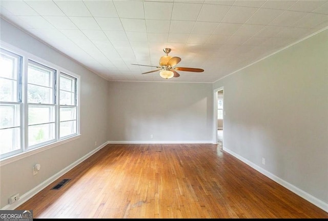 unfurnished room featuring ceiling fan, ornamental molding, and light wood-type flooring