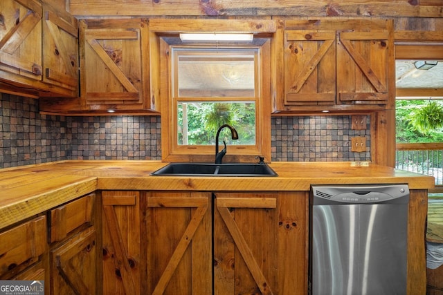 kitchen featuring sink, backsplash, a wealth of natural light, and dishwasher