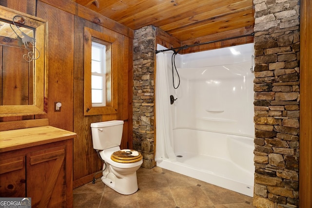 bathroom featuring tile patterned flooring, vanity, wood ceiling, walk in shower, and toilet