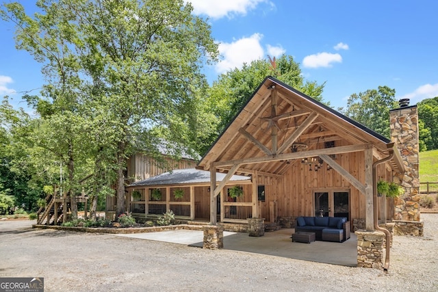 exterior space with an outdoor hangout area and a patio area