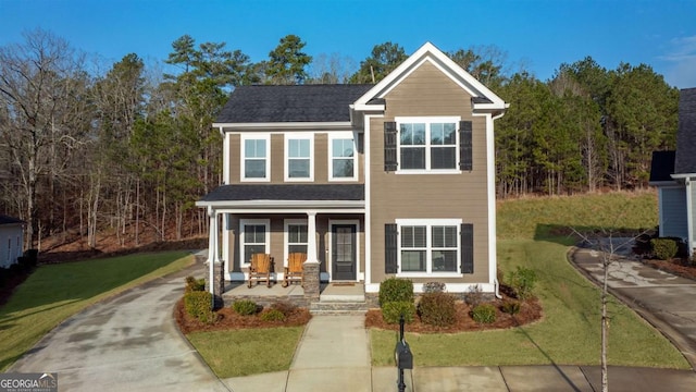 view of front of property featuring covered porch and a front lawn