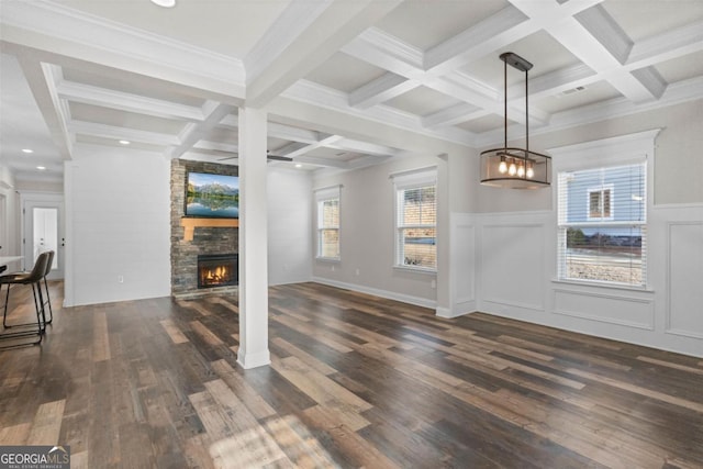 unfurnished living room featuring coffered ceiling, beam ceiling, crown molding, dark hardwood / wood-style floors, and a fireplace