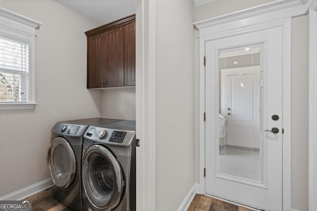 laundry area with cabinets, dark wood-type flooring, and independent washer and dryer