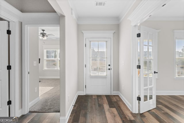 doorway to outside with crown molding, dark wood-type flooring, and a wealth of natural light