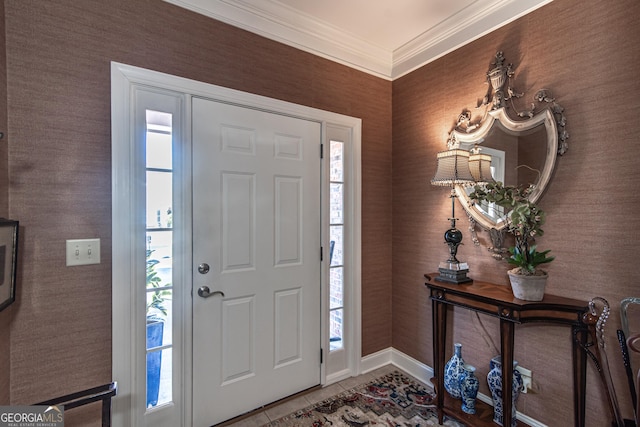 foyer entrance with crown molding and tile patterned flooring