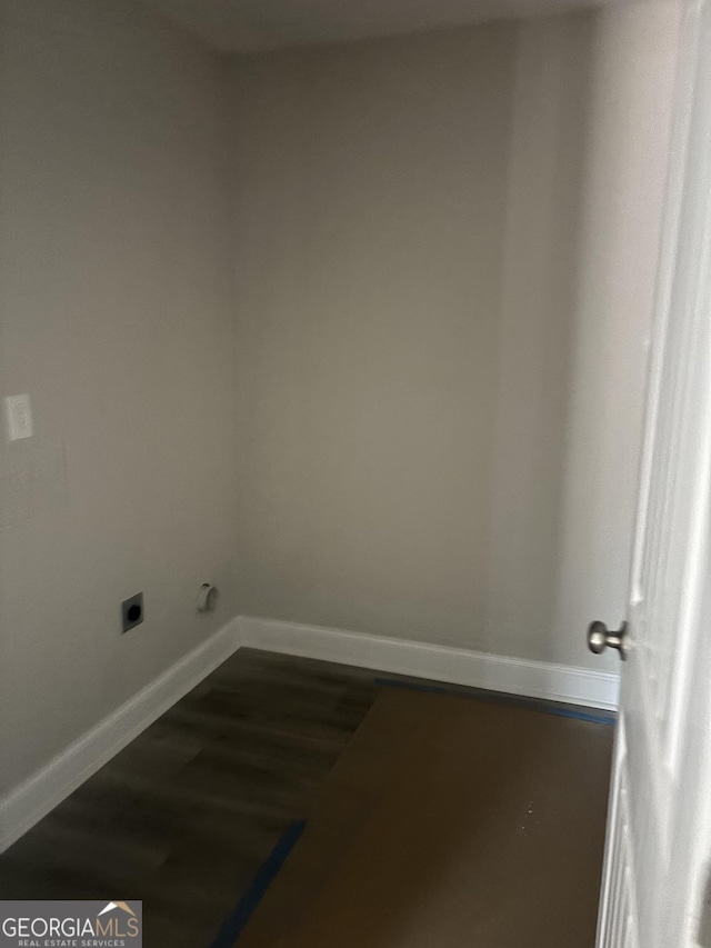 laundry area with hookup for an electric dryer and dark hardwood / wood-style flooring