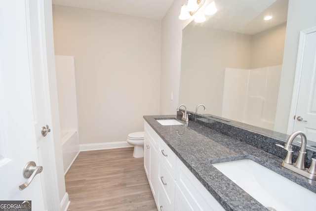 full bathroom with hardwood / wood-style flooring, vanity, toilet, and shower with separate bathtub