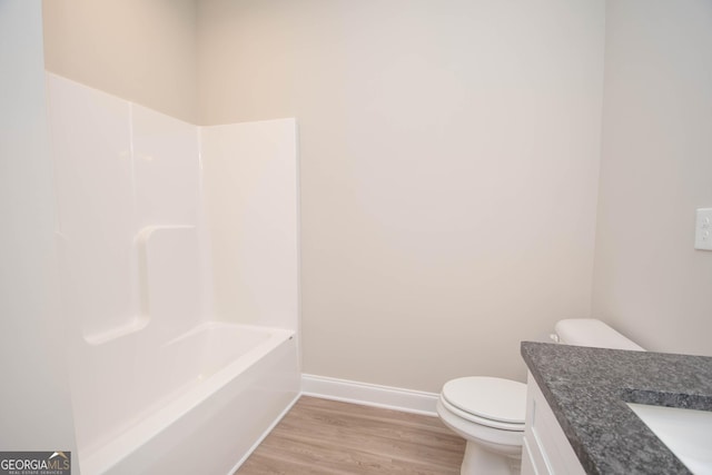 bathroom featuring hardwood / wood-style flooring, vanity, and toilet