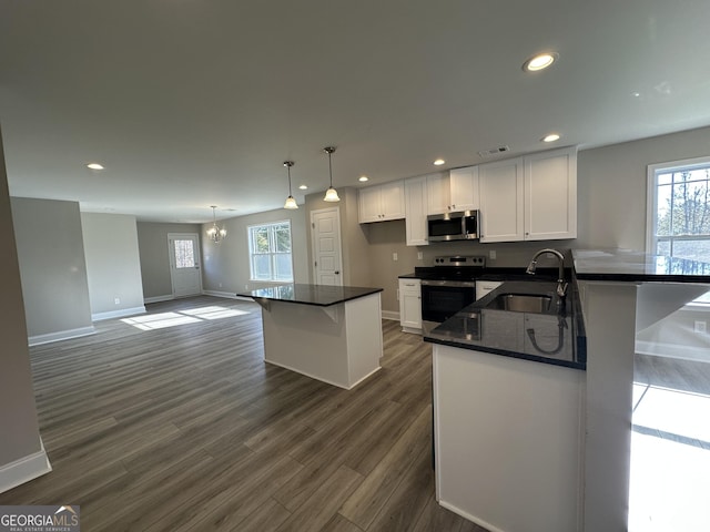 kitchen featuring visible vents, recessed lighting, appliances with stainless steel finishes, white cabinets, and a sink