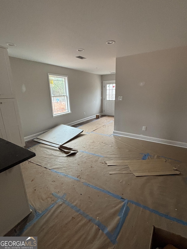 unfurnished room featuring baseboards