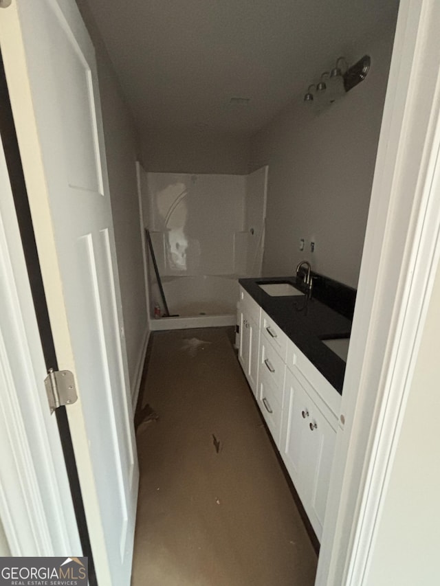 bathroom with vanity and a shower