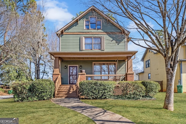 view of front of home with a porch and a front lawn