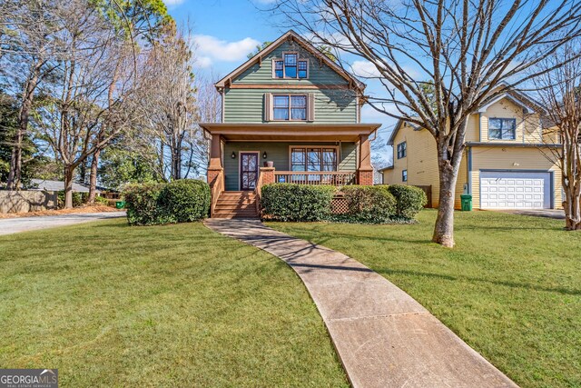 view of front of property featuring a porch, a garage, and a front yard