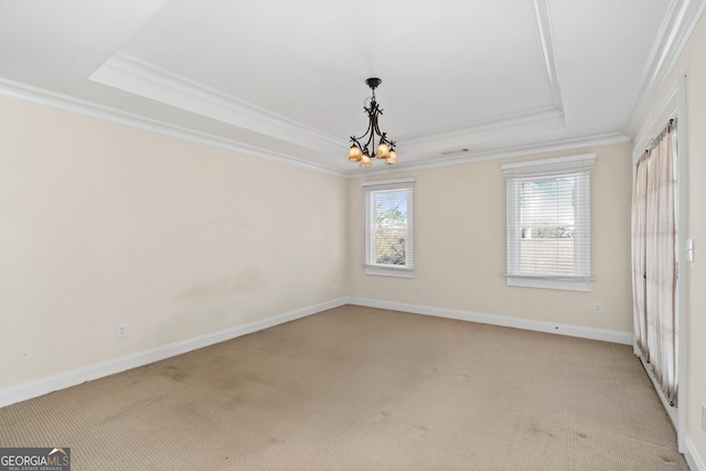 unfurnished room featuring light carpet, baseboards, a tray ceiling, and crown molding