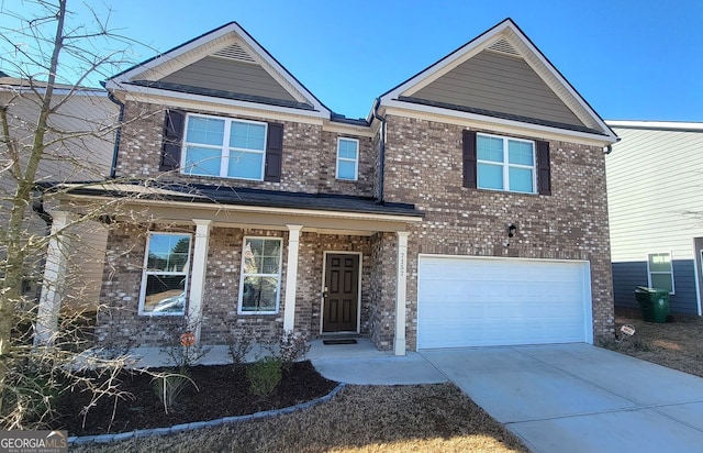 view of front of house with a garage, brick siding, and driveway