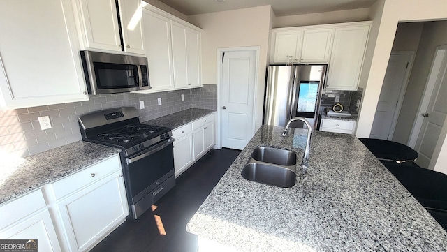 7157 Gladstone, Stonecrest, GA 30038 - kitchen featuring stainless steel appliances, white cabinetry, a sink, and light stone counters