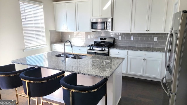 7157 Gladstone, Stonecrest, GA 30038 - kitchen featuring light stone counters, tasteful backsplash, appliances with stainless steel finishes, white cabinets, and a sink