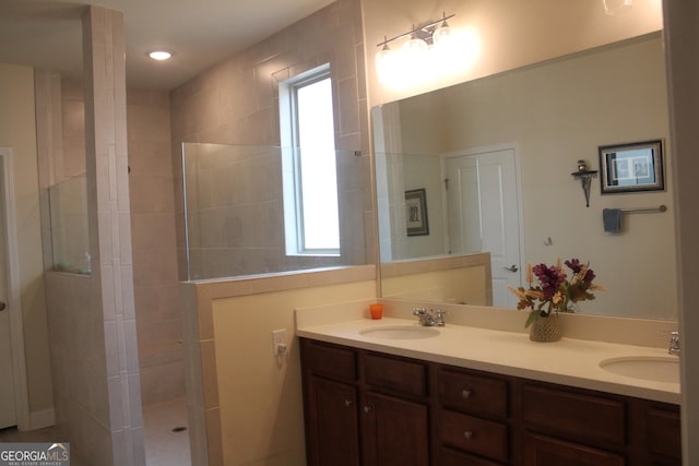 bathroom with vanity and tiled shower