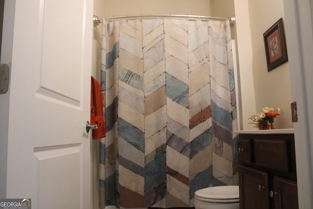 bathroom with vanity, toilet, and a shower with shower curtain