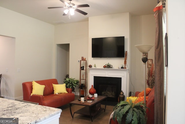 living room featuring ceiling fan and hardwood / wood-style floors