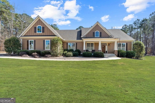 craftsman-style home featuring a front yard and covered porch