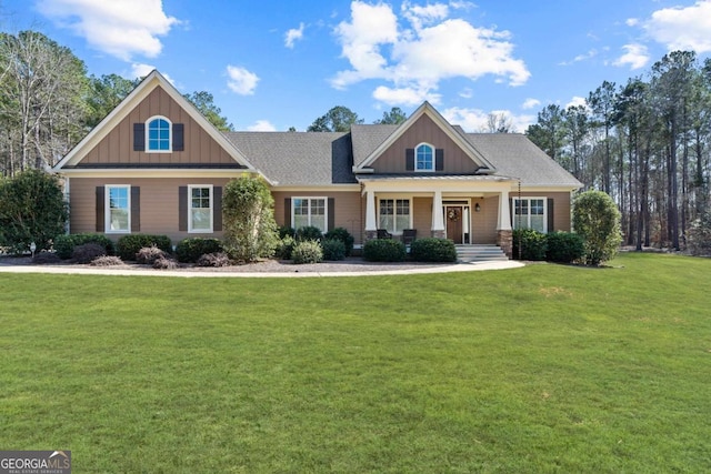 craftsman house with a front lawn and a porch