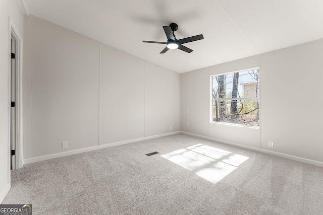 carpeted spare room with vaulted ceiling and ceiling fan