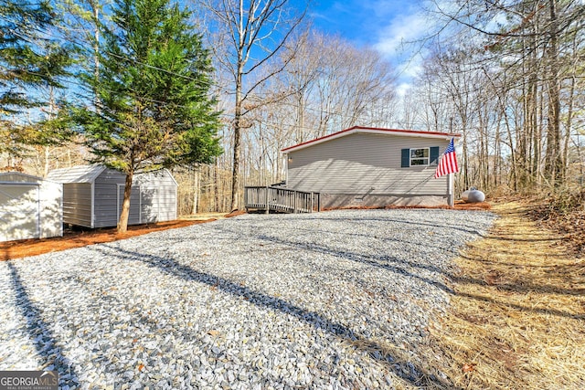 view of side of property featuring a shed and a deck