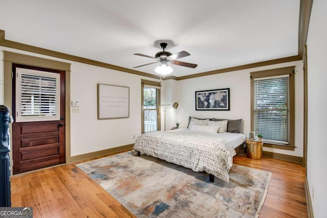 bedroom featuring ornamental molding, hardwood / wood-style floors, and ceiling fan