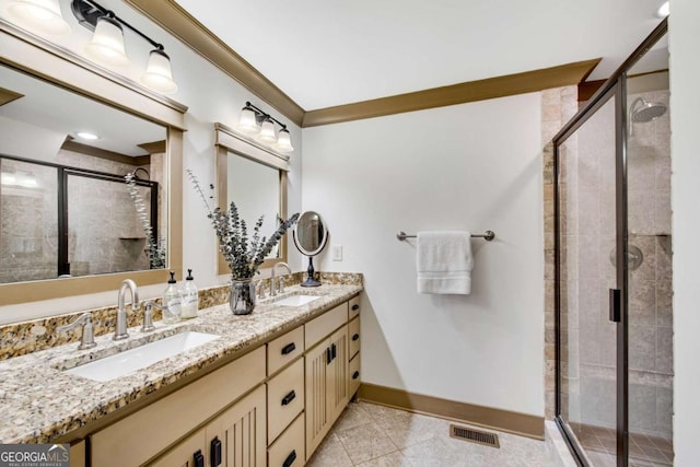 bathroom featuring crown molding, vanity, a shower with shower door, and tile patterned flooring