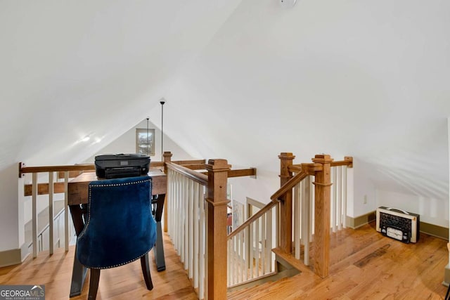 interior space featuring lofted ceiling and light hardwood / wood-style floors