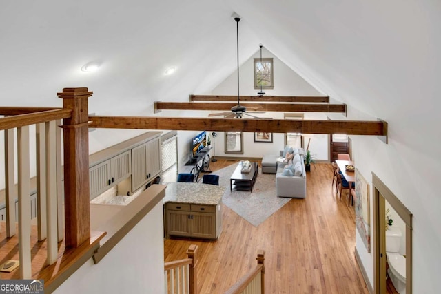 living room featuring ceiling fan, high vaulted ceiling, and light hardwood / wood-style floors