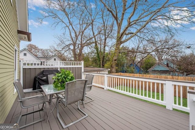 wooden deck with a grill