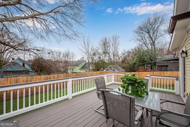 wooden terrace featuring a yard