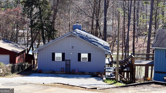 exterior space featuring a wooden deck and a garage