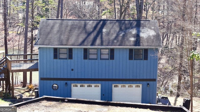 exterior space featuring a wooden deck and a garage