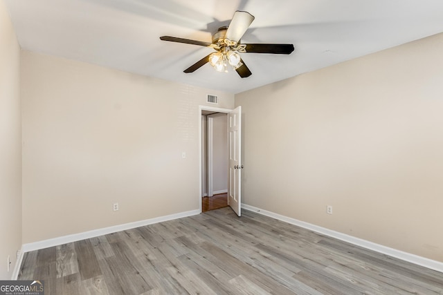 spare room with light hardwood / wood-style floors and ceiling fan