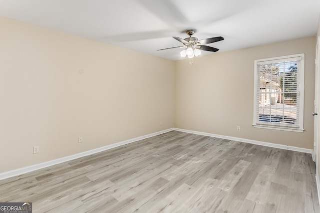 spare room with light hardwood / wood-style floors and ceiling fan