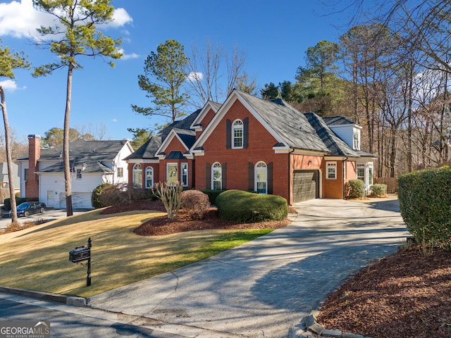 view of front of home featuring a garage and a front lawn