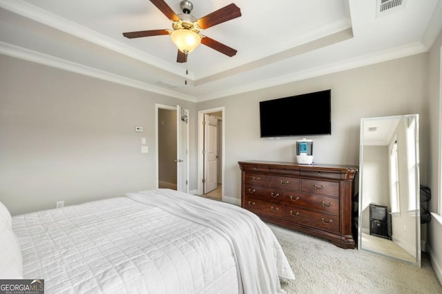 carpeted bedroom with a raised ceiling, ceiling fan, and crown molding