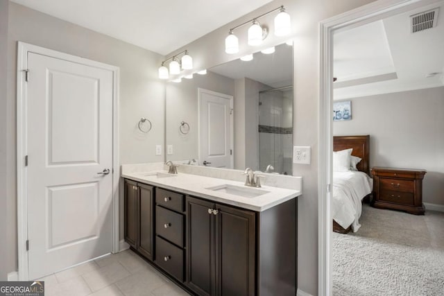 bathroom with vanity, an enclosed shower, and tile patterned floors