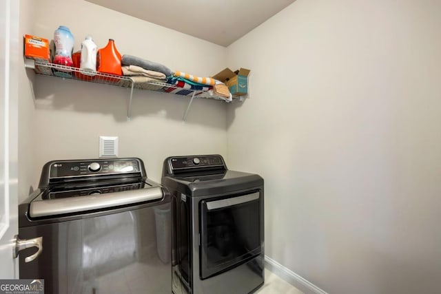 washroom with washing machine and dryer