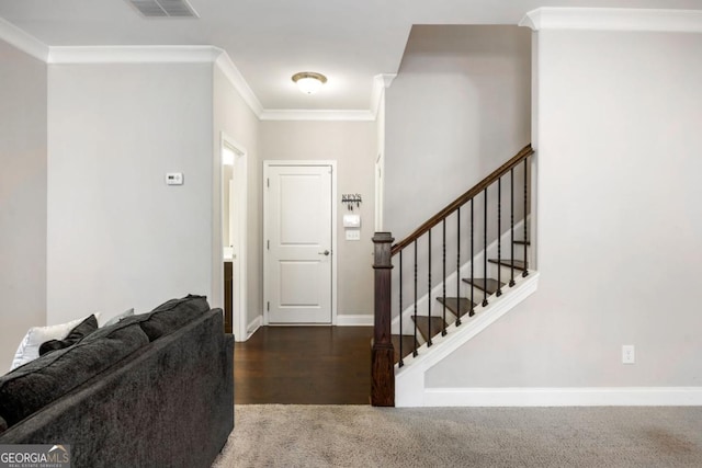 entryway featuring crown molding and dark hardwood / wood-style floors