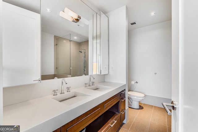 bathroom featuring tile patterned floors, toilet, vanity, and walk in shower