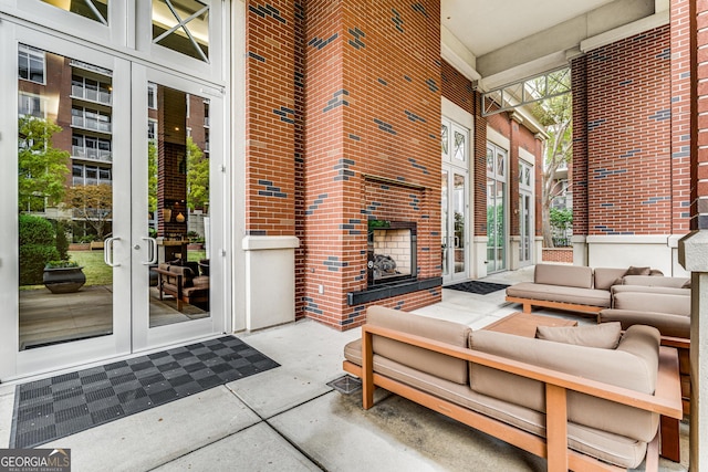 exterior space with french doors and an outdoor living space with a fireplace