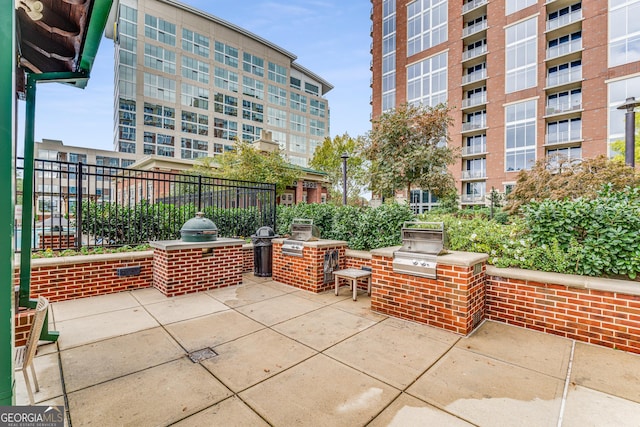 view of patio featuring area for grilling and a grill